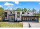 Beautiful modern home with a two-car garage and balcony on a well-manicured lawn at 4238 Hamilton Mill Rd, Buford, GA 30519