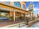 A charming brick building with a clock tower, wooden accents, and flower-filled planters at 4238 Hamilton Mill Rd, Buford, GA 30519