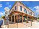 Exterior view of a charming brick building with a clock tower and inviting storefronts, perfect for retail or dining at 4238 Hamilton Mill Rd, Buford, GA 30519