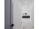 Hallway with marble flooring leads to bathroom featuring double vanity at 4238 Hamilton Mill Rd, Buford, GA 30519