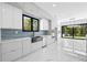 Modern kitchen with stainless steel appliances, marble countertops, and a blue tile backsplash at 4238 Hamilton Mill Rd, Buford, GA 30519