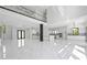 Open-concept living space with marble floors, a modern kitchen, and recessed lighting, creating a sleek and airy atmosphere at 4238 Hamilton Mill Rd, Buford, GA 30519