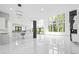 Bright, open-concept living space features marble floors, a modern kitchen, and floor-to-ceiling windows with a view at 4238 Hamilton Mill Rd, Buford, GA 30519