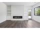 Stylish living room featuring modern flooring, fireplace, and access to the outdoor deck at 4238 Hamilton Mill Rd, Buford, GA 30519