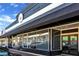 A charming storefront with a black awning, large windows, and a welcoming entrance, perfect for local businesses at 4238 Hamilton Mill Rd, Buford, GA 30519