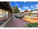 Street view showcasing a brick sidewalk lined with stores, parked cars, and charming architectural details at 4238 Hamilton Mill Rd, Buford, GA 30519