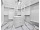 Impressive walk-in closet with custom storage and marble floors at 4238 Hamilton Mill Rd, Buford, GA 30519