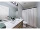 Well-lit bathroom with a white vanity, decorative mirror, and shower curtain at 2151 Jonquil Ct, Canton, GA 30115