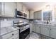 Close up of modern kitchen with stainless steel appliances and granite countertops at 2151 Jonquil Ct, Canton, GA 30115