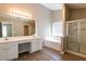 A modern bathroom features double sinks, a soaking tub, and a glass-enclosed shower at 2535 Fairmont Park Ct, Dacula, GA 30019