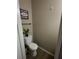 Cozy powder room featuring a toilet and a decorative plant at 2535 Fairmont Park Ct, Dacula, GA 30019