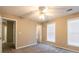 A bright bedroom features a ceiling fan, neutral walls, and a window to let the light in at 2535 Fairmont Park Ct, Dacula, GA 30019