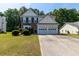 Charming two-story home featuring a well-manicured lawn, brick accents, and a convenient two-car garage at 2535 Fairmont Park Ct, Dacula, GA 30019