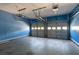 Spacious two-car garage with blue walls and automatic door openers at 2535 Fairmont Park Ct, Dacula, GA 30019