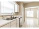 Bright kitchen with stainless steel appliances, white cabinets, and a view into the dining area at 2535 Fairmont Park Ct, Dacula, GA 30019