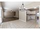 Open layout showcasing kitchen with white cabinets, tile floor, and seamless flow into the living area at 2535 Fairmont Park Ct, Dacula, GA 30019