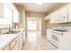 Clean kitchen featuring white appliances, plenty of counter space, and tile flooring at 2535 Fairmont Park Ct, Dacula, GA 30019