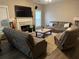 Cozy living room featuring a fireplace, plush seating, and plenty of natural light at 2535 Fairmont Park Ct, Dacula, GA 30019