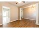 Stylish living area with hardwood floors, decorative columns, and view into a tiled kitchen at 2535 Fairmont Park Ct, Dacula, GA 30019