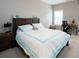 Bedroom with a large bed, wooden desk, neutral carpet, and one bright window at 4280 Castlewood Rd, Cumming, GA 30040