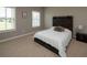 Bedroom features two windows and a wooden headboard with lighting at 4280 Castlewood Rd, Cumming, GA 30040