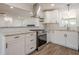 Modern kitchen with stainless steel appliances, granite countertops, and stylish white cabinets at 5265 Springtide Ln, Powder Springs, GA 30127