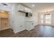 Well-lit kitchen with white cabinets, modern appliances, and a view of the dining space at 5265 Springtide Ln, Powder Springs, GA 30127