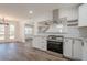 Modern kitchen with stainless steel appliances, granite countertops, and bright white cabinets at 5265 Springtide Ln, Powder Springs, GA 30127