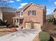 Two-story brick home featuring a manicured lawn, attached two-car garage, and inviting front porch at 5912 Sharp Se Dr, Mableton, GA 30126