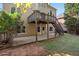 Backyard view of two story home with large windows, deck, patio, and lawn at 625 Jefferson Pl, Cumming, GA 30040