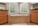 Bright bathroom showcasing a soaking tub, tile surround, and maple cabinets at 625 Jefferson Pl, Cumming, GA 30040