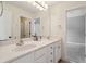 Bathroom boasting dual vanities with white cabinets and a large mirror at 625 Jefferson Pl, Cumming, GA 30040