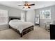 Bright bedroom with plush carpeting, a ceiling fan, and many windows at 625 Jefferson Pl, Cumming, GA 30040