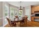 Dining room with wood table, chairs, and a hutch with granite countertop at 625 Jefferson Pl, Cumming, GA 30040