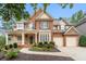 Beautiful brick home with a manicured front yard, covered porch, and two-car garage at 625 Jefferson Pl, Cumming, GA 30040