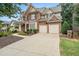 Traditional brick home with a well-manicured lawn and a two-car garage at 625 Jefferson Pl, Cumming, GA 30040