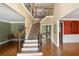 Grand foyer featuring hardwood floors, staircase, and lots of natural light at 625 Jefferson Pl, Cumming, GA 30040