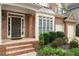 Charming brick home featuring a covered front porch and landscaped garden at 625 Jefferson Pl, Cumming, GA 30040