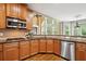 Kitchen featuring stainless steel appliances, tile backsplash, and wood floors at 625 Jefferson Pl, Cumming, GA 30040