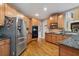 Kitchen with granite countertops, stainless steel appliances, and wood cabinets at 625 Jefferson Pl, Cumming, GA 30040