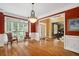 Formal living room featuring hardwood floors, crown molding, and a decorative chandelier at 625 Jefferson Pl, Cumming, GA 30040