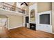 Bright living room features hardwood floors, fireplace, and built-in shelving and cabinets at 625 Jefferson Pl, Cumming, GA 30040