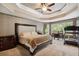 Bright main bedroom features tray ceilings, carpeted floors, and sitting area at 625 Jefferson Pl, Cumming, GA 30040