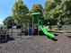 Colorful community playground with a slide, climbing wall, and monkey bars at 625 Jefferson Pl, Cumming, GA 30040