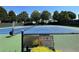 Community tennis courts with proper signage and new net at 625 Jefferson Pl, Cumming, GA 30040