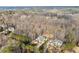 An elevated view showing the arrangement of houses nestled in a wooded, suburban landscape at 1355 Cashiers Way, Roswell, GA 30075