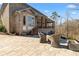 The home's backyard features a cozy patio with a stone fire pit and lush landscaping at 1355 Cashiers Way, Roswell, GA 30075