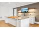 Basement wet bar with stone counters, custom cabinets, brick accent wall, and flat screen TV at 1355 Cashiers Way, Roswell, GA 30075