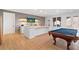 Finished basement featuring a billiards table, wet bar, brick accent wall, and stylish lighting at 1355 Cashiers Way, Roswell, GA 30075