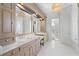 Luxurious bathroom with dual vanities, marble counters, and custom cabinetry at 1355 Cashiers Way, Roswell, GA 30075